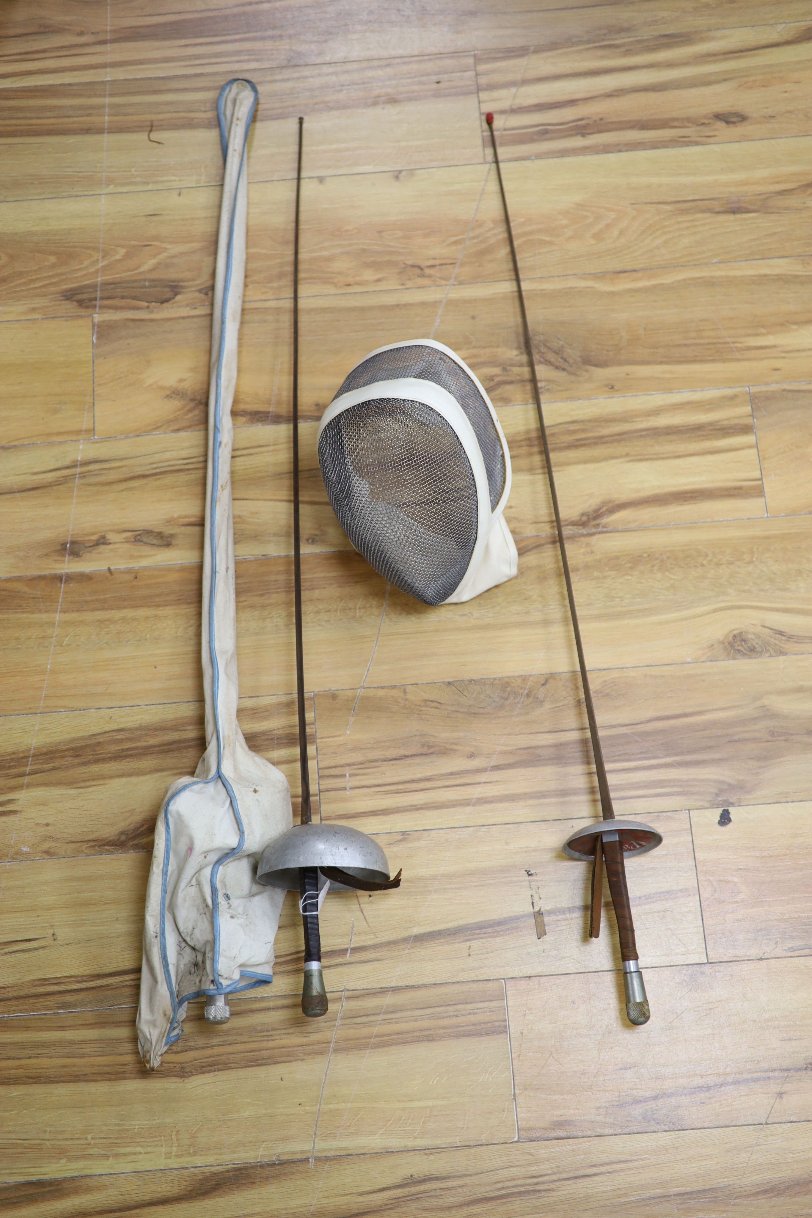 A fencing foil and accessories